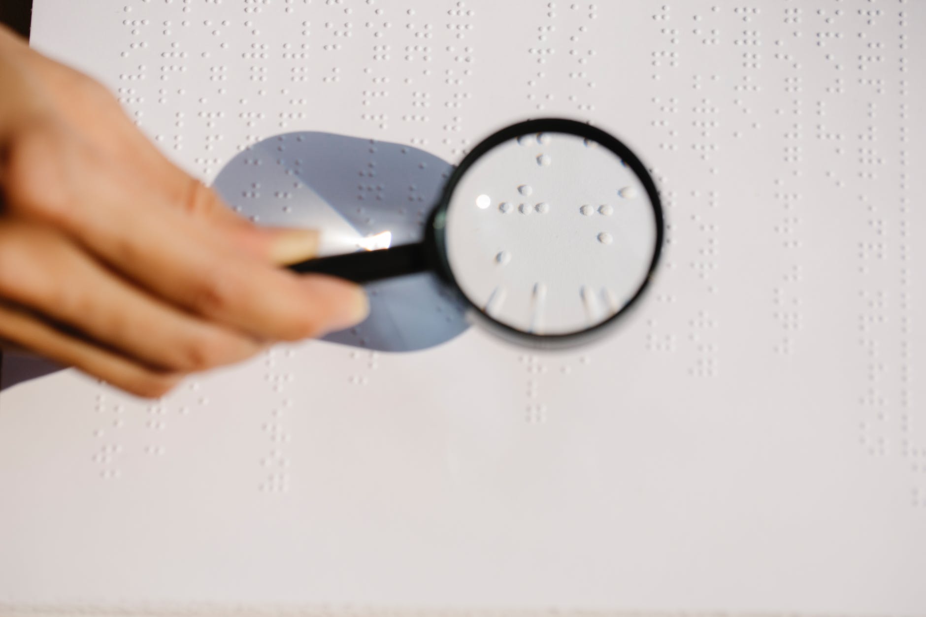photo of person holding magnifying glass